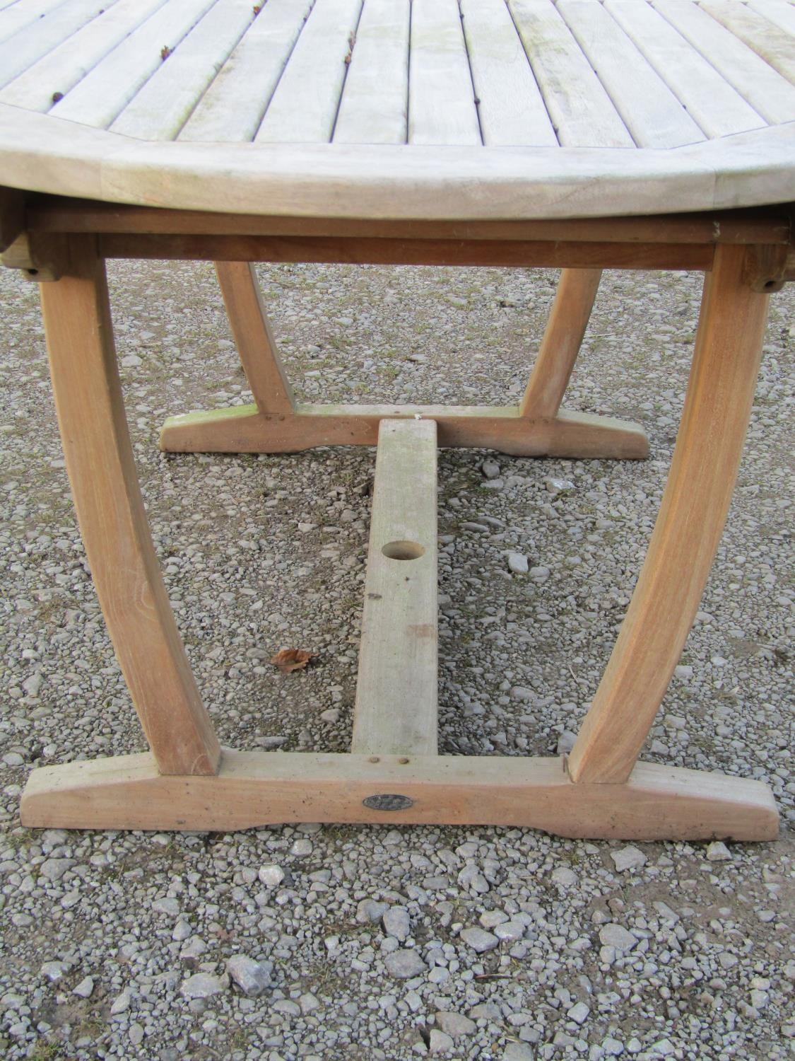A contemporary Cotswold Collection weathered teak garden table with oval slatted top raised on - Image 5 of 6