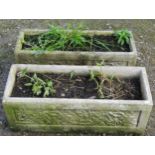 A pair of weathered cast composition stone rectangular flower troughs with foliate relief panels, 25