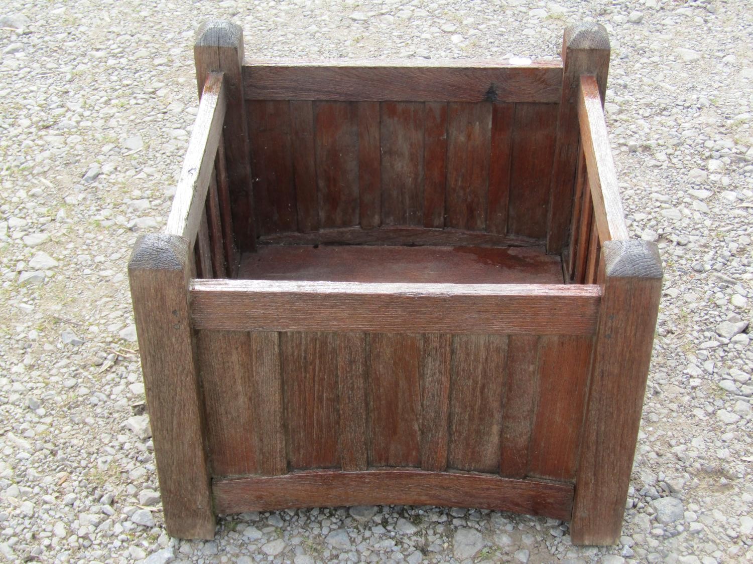A pair of stained and weathered teak garden planters with facetted square cut supports and slatted - Image 3 of 7