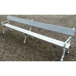 A long park/railway waiting bench with painted finish, wooden slatted seat and back rail raised on