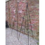 A weathered tall pyramid shaped steel garden obelisk with open scroll finial approx 240 cm high