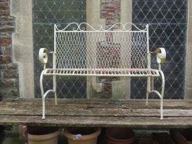 A small decorative weathered cream painted two seat garden folding garden bench with lattice and