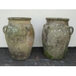 A large pair of weathered terracotta planters of tapering baluster form, each fitted with four