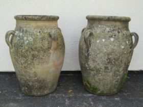 A large pair of weathered terracotta planters of tapering baluster form, each fitted with four