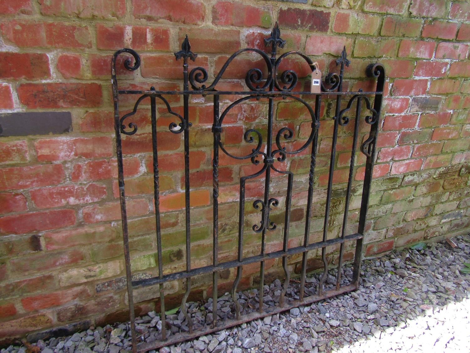 A heavy gauge iron gate with decorative open scroll work detail and spearhead finials, 121cm high - Image 2 of 4