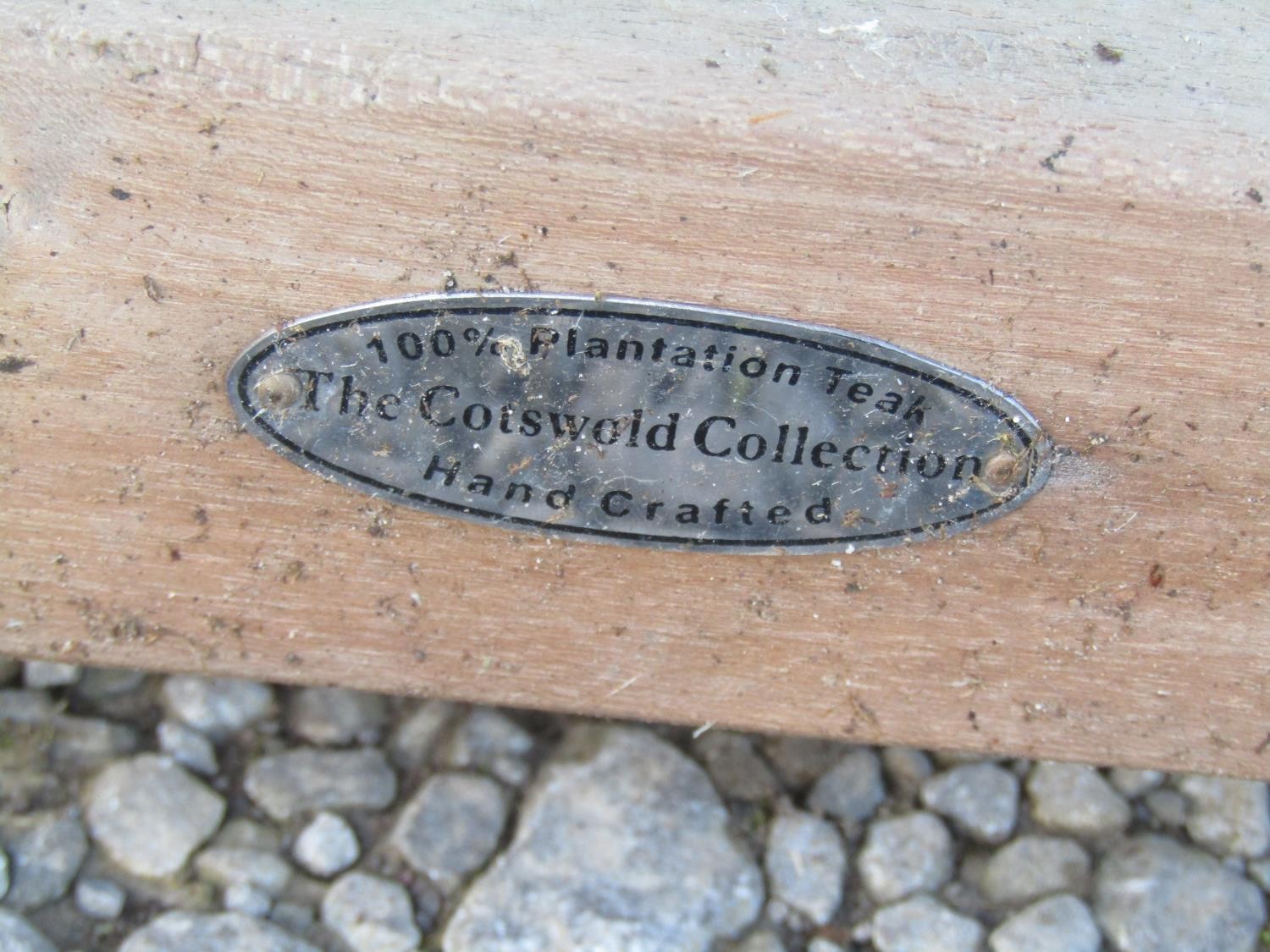 A contemporary Cotswold Collection weathered teak garden table with oval slatted top raised on - Image 6 of 6