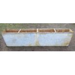 An unusual heavy gauge narrow rectangular water tank/trough with three rung divisions and tap to one