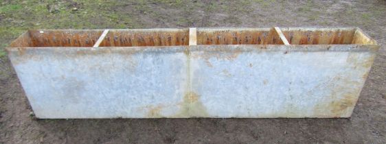 An unusual heavy gauge narrow rectangular water tank/trough with three rung divisions and tap to one