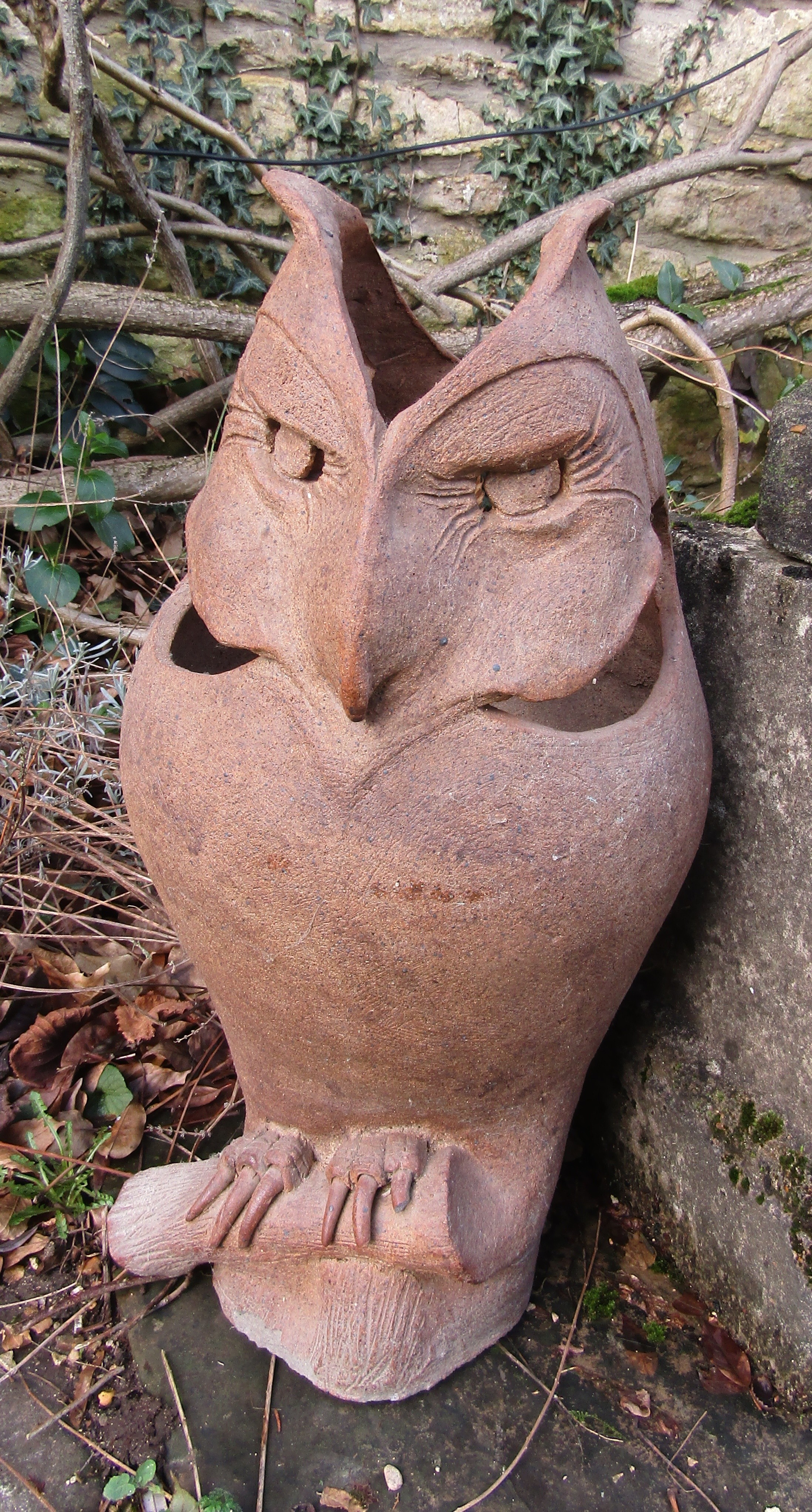 A salt glazed figure of an owl with pierced and incised detail, 55 cm high
