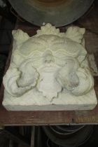 A deep carved stone green man hanging wall plaque (carved from a single block of stone) 36 cm square