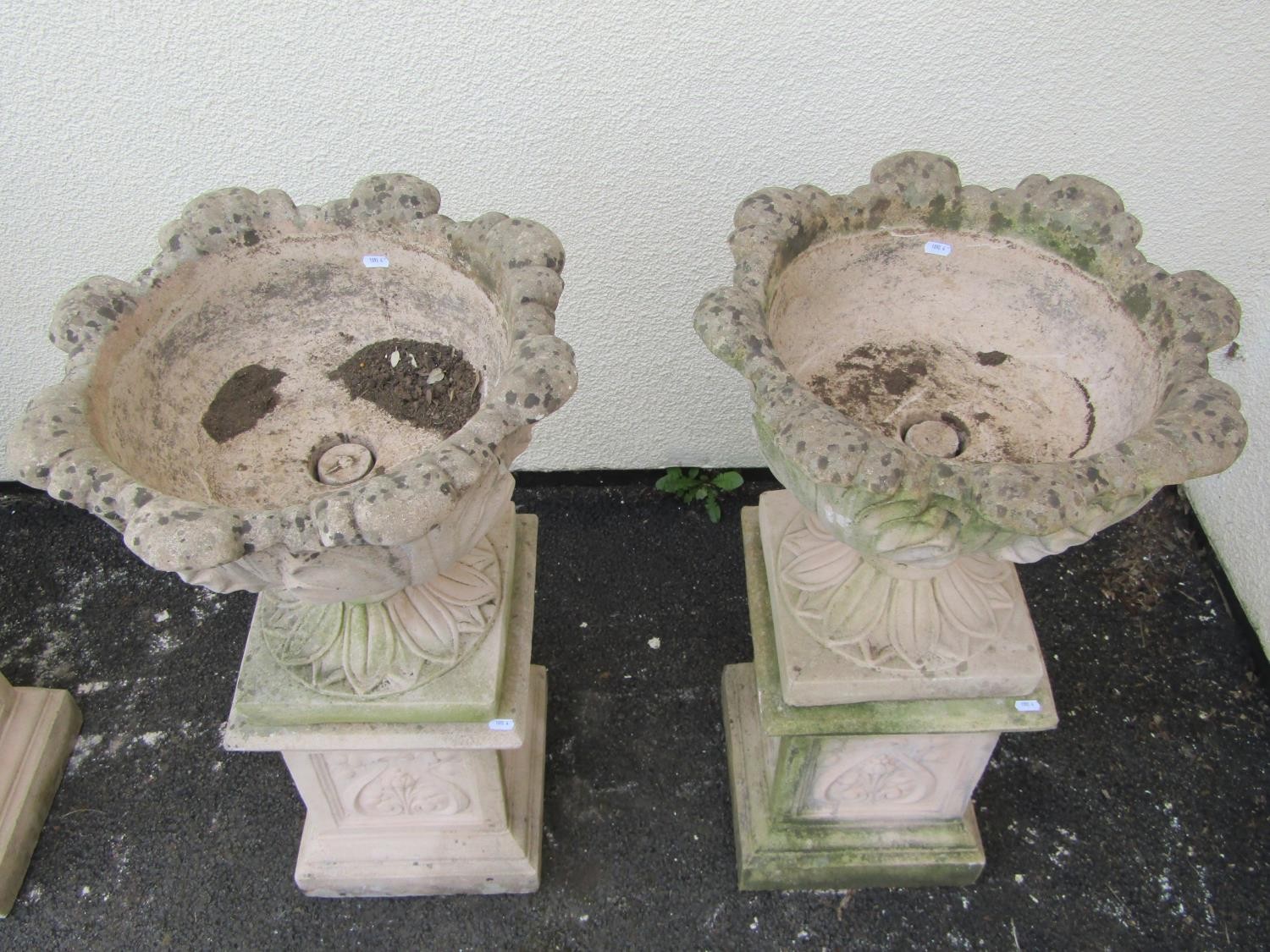 A pair of cast composition stone garden urns with circular acanthus leaf bowls raised on loose - Image 2 of 3