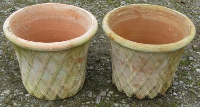 A pair of contemporary terracotta planters in the form of lattice baskets, 32 cm high x 40 cm