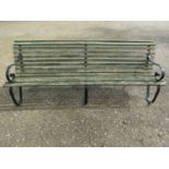 A vintage heavy gauge park/estate garden bench with weathered green painted teak slatted seat raised