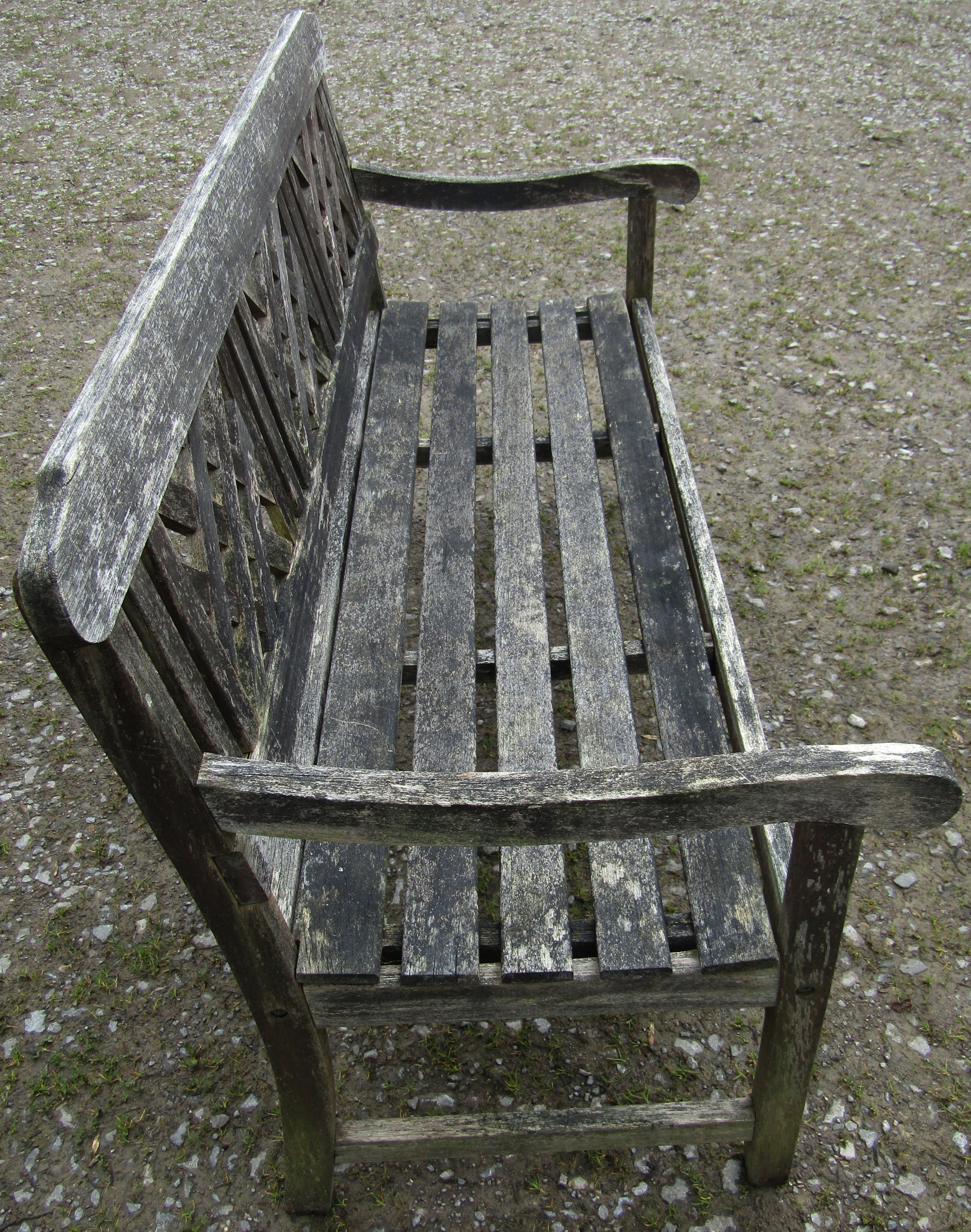 A weathered three seat garden bench with slatted seat and lattice panelled back beneath a shaped - Image 2 of 5
