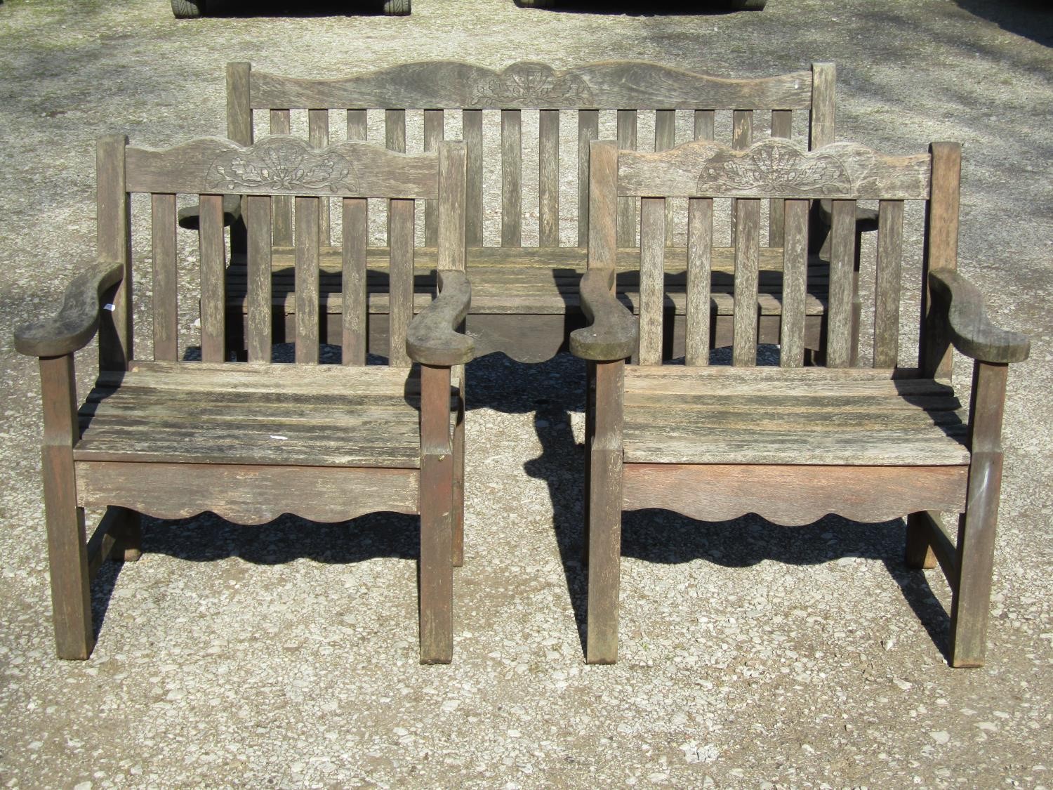 A Bridgman & Co Ltd stained and weathered teak three seat garden bench 161 cm wide and a pair of