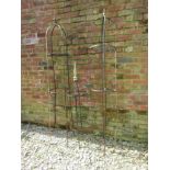 A pair of weathered steel obelisks of domed cylindrical form with spear head finials, 37cm