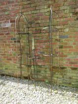 A pair of weathered steel obelisks of domed cylindrical form with spear head finials, 37cm