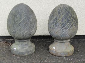 A pair of weathered cast iron pineapple pier finials, 46 cm high