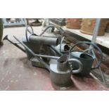 A quantity of vintage galvanised ware to include a selection of watering cans of varying size,