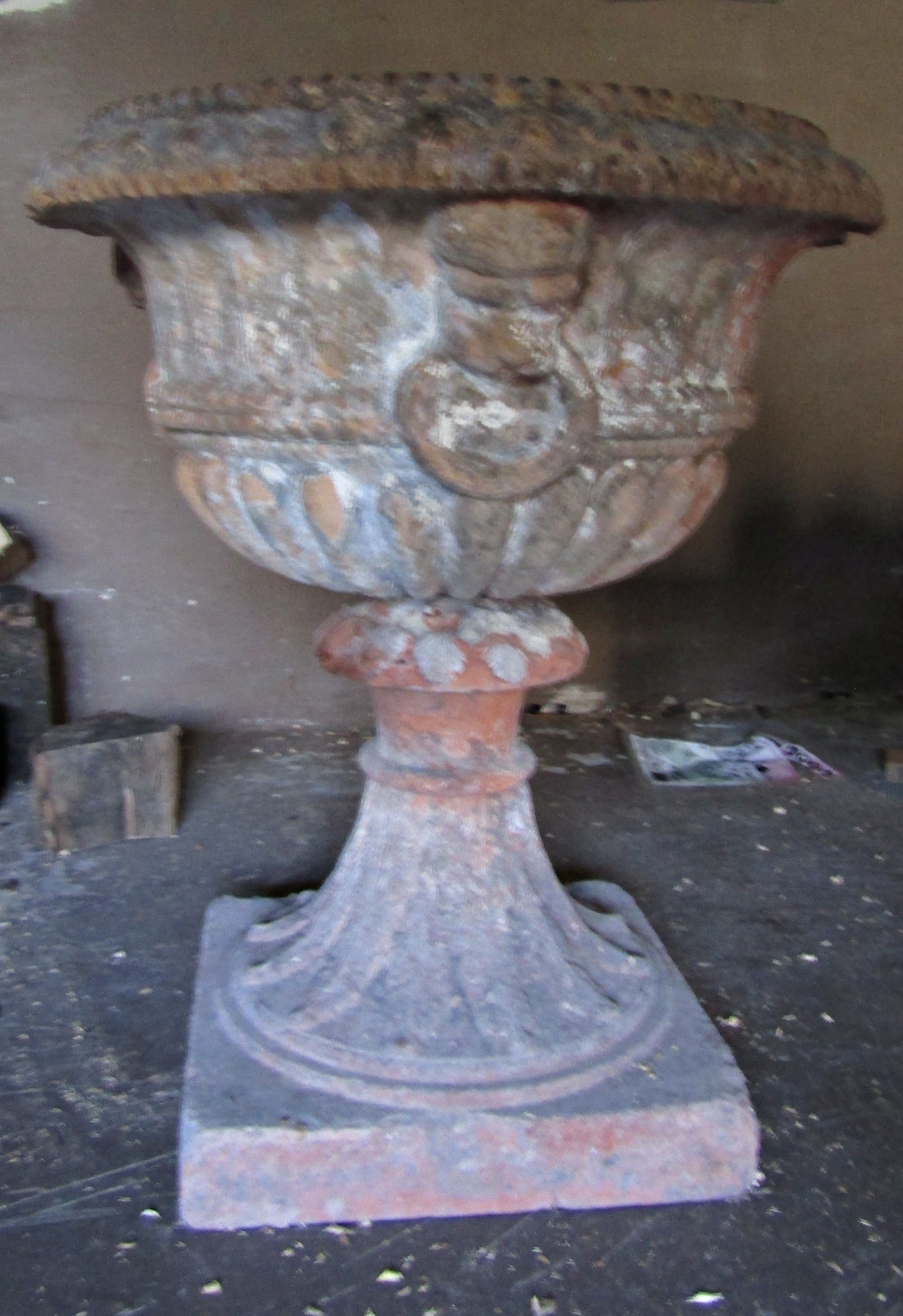 19th century terracotta urn of classical form with fluted detail, mask and ring handle - old repairs
