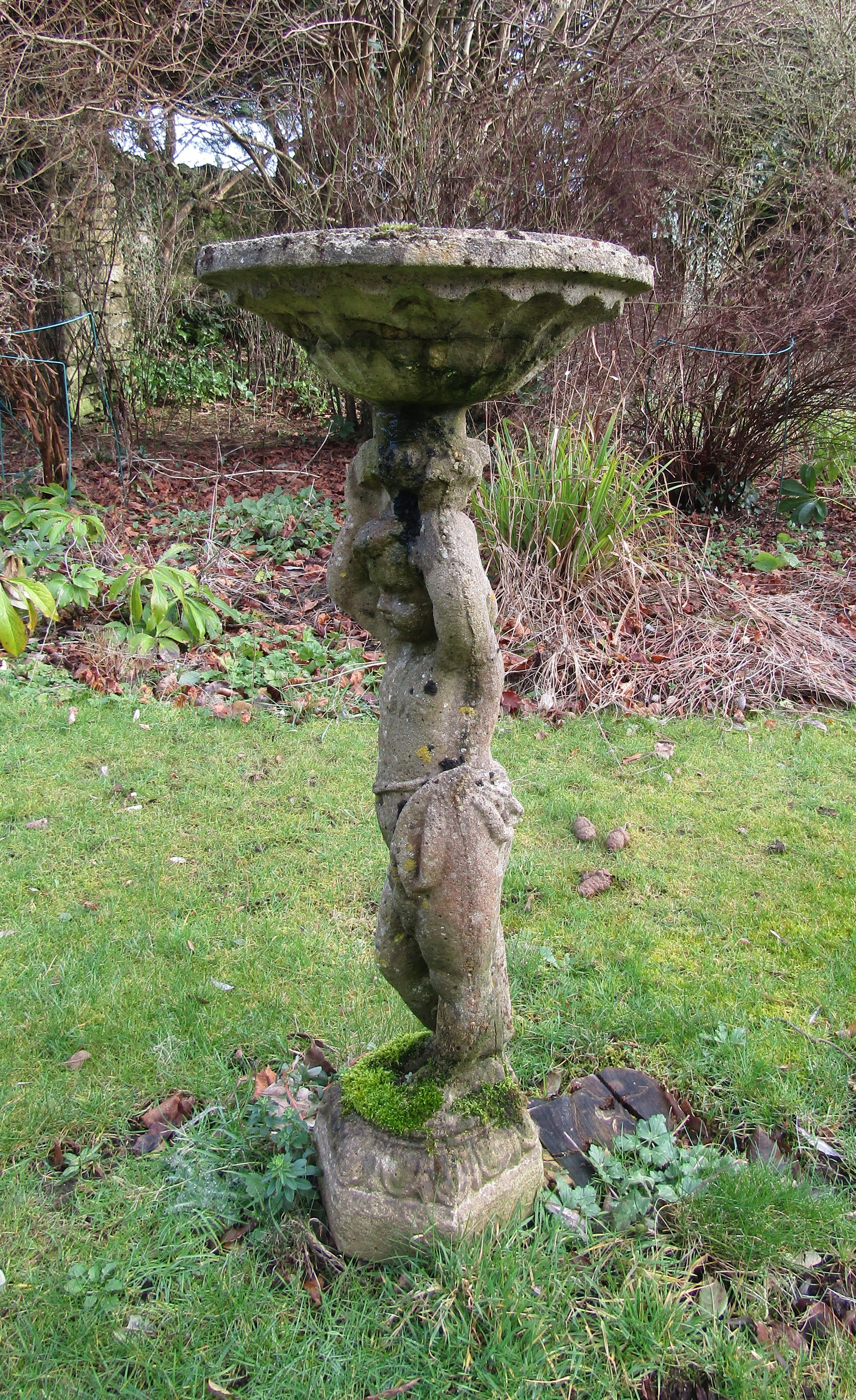 A weathered reconstituted bird bath, the column in the form of a boy, arms aloft, old repairs, 95 cm - Image 3 of 3