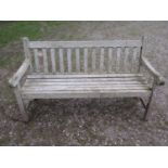 A weathered teak Tiger Trading three seat traditional garden bench with slatted seat and back, 153cm