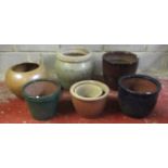 Seven garden planters of varying size and design including glazed examples, one with combed
