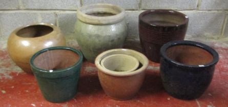 Seven garden planters of varying size and design including glazed examples, one with combed
