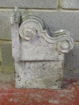A carved natural stone corbel with scroll detail 40 cm high x 53 cm x 24 cm
