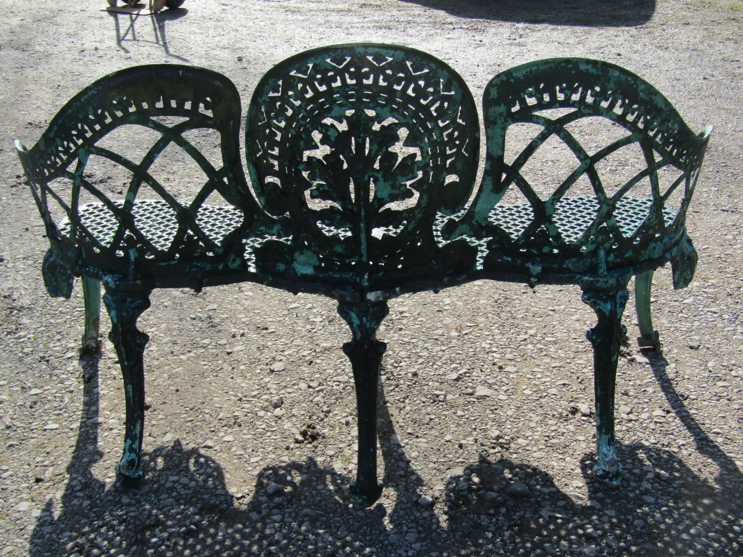 A weathered green painted cast alloy garden bench with shaped outline and decorative pierced - Image 7 of 10