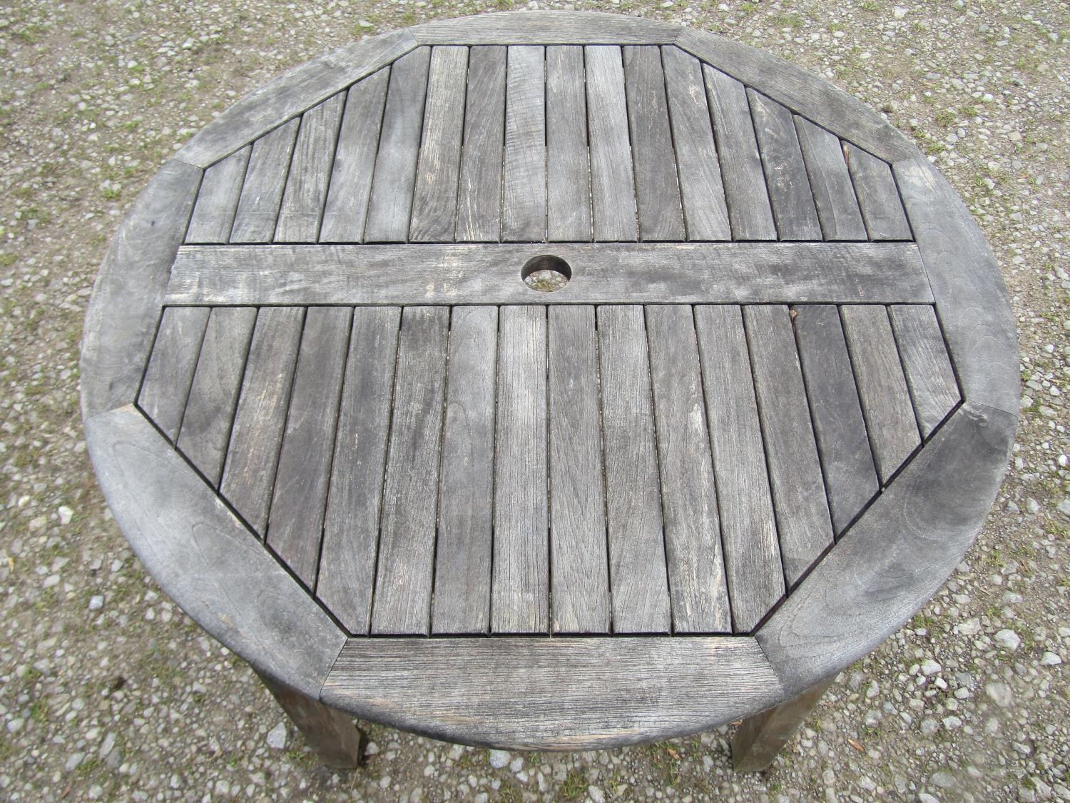 A weathered circular teak table and four associated armchairs (5) - Image 7 of 8