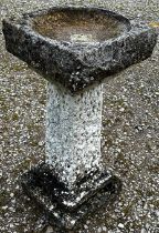 A five sectional cast to simulate rough hewn stone garden bird bath of square cut and stepped