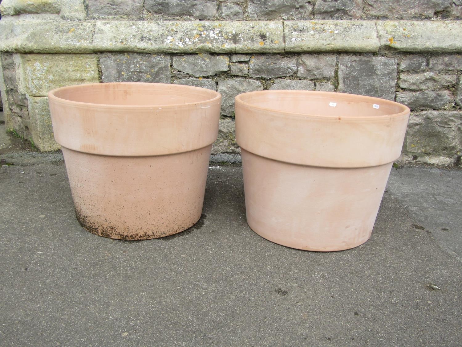 A pair of contemporary terracotta planters of circular tapered form with wide collars, 39m high x
