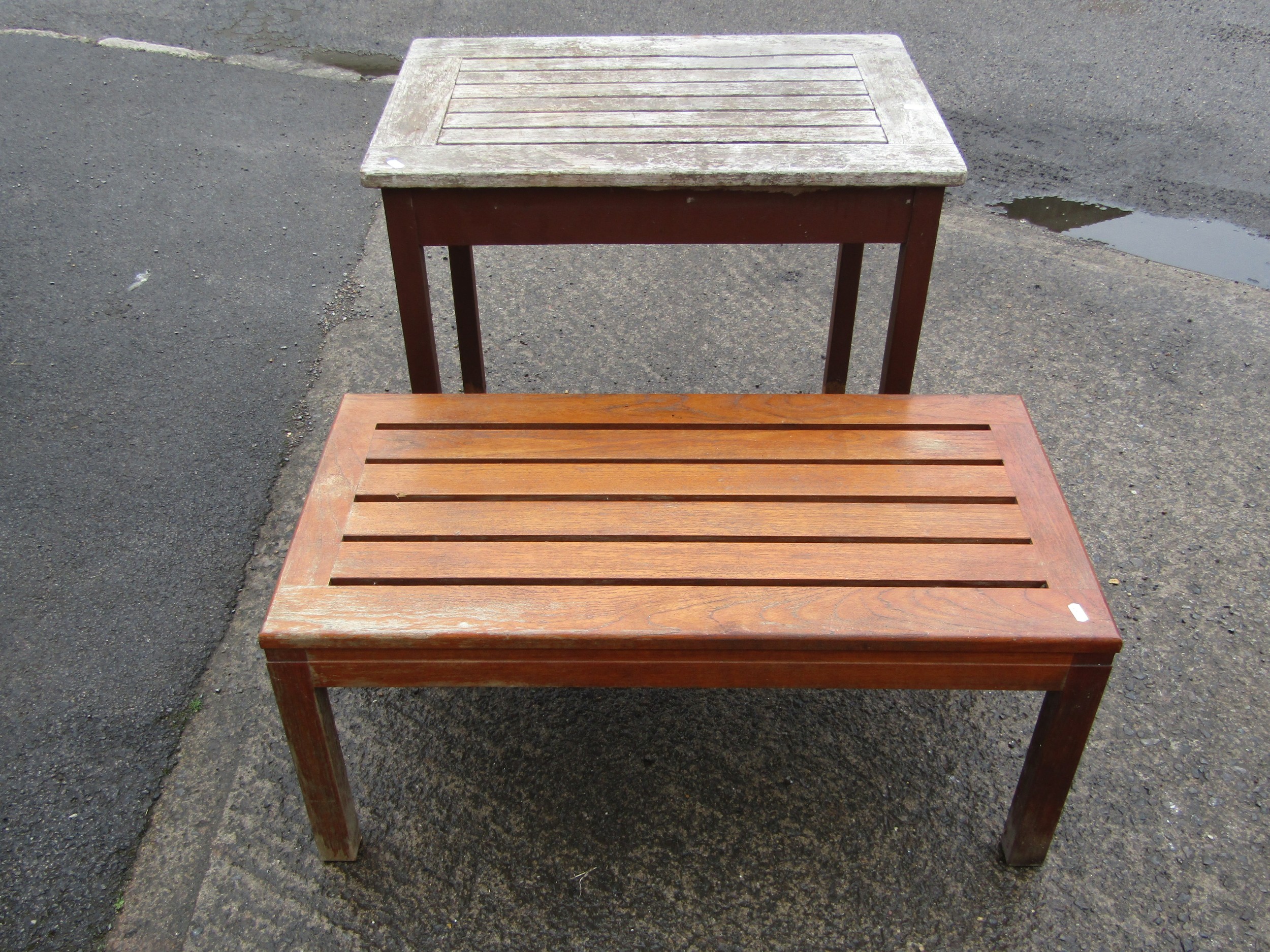 A vintage stained and weathered Lister burma teak garden table of rectangular form with slatted