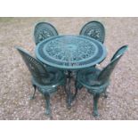 A green painted cast aluminium garden terrace table of circular form, with decorative pierced top,