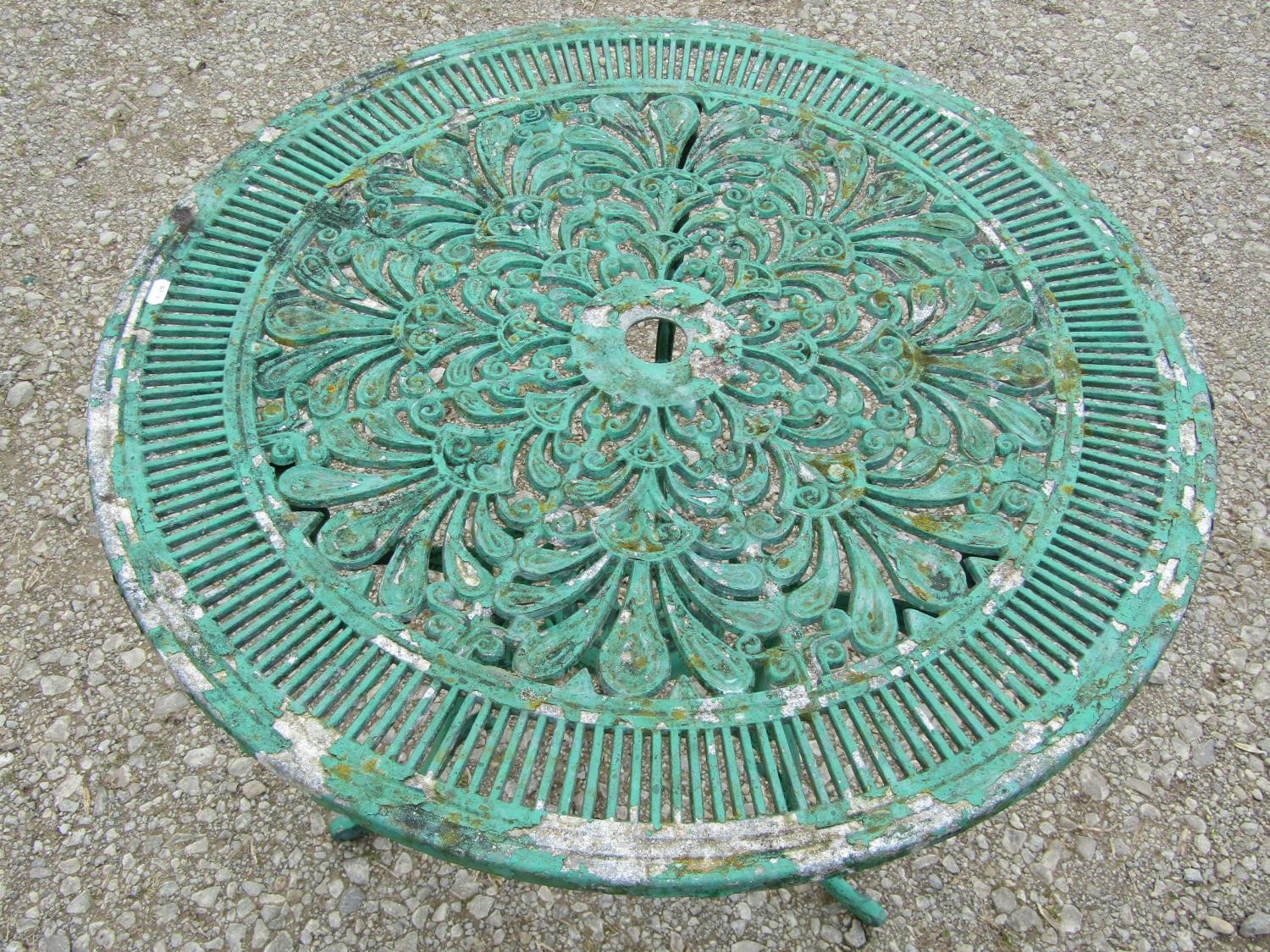 A weathered green painted cast aluminium garden terrace table of circular form with decorative - Image 4 of 4