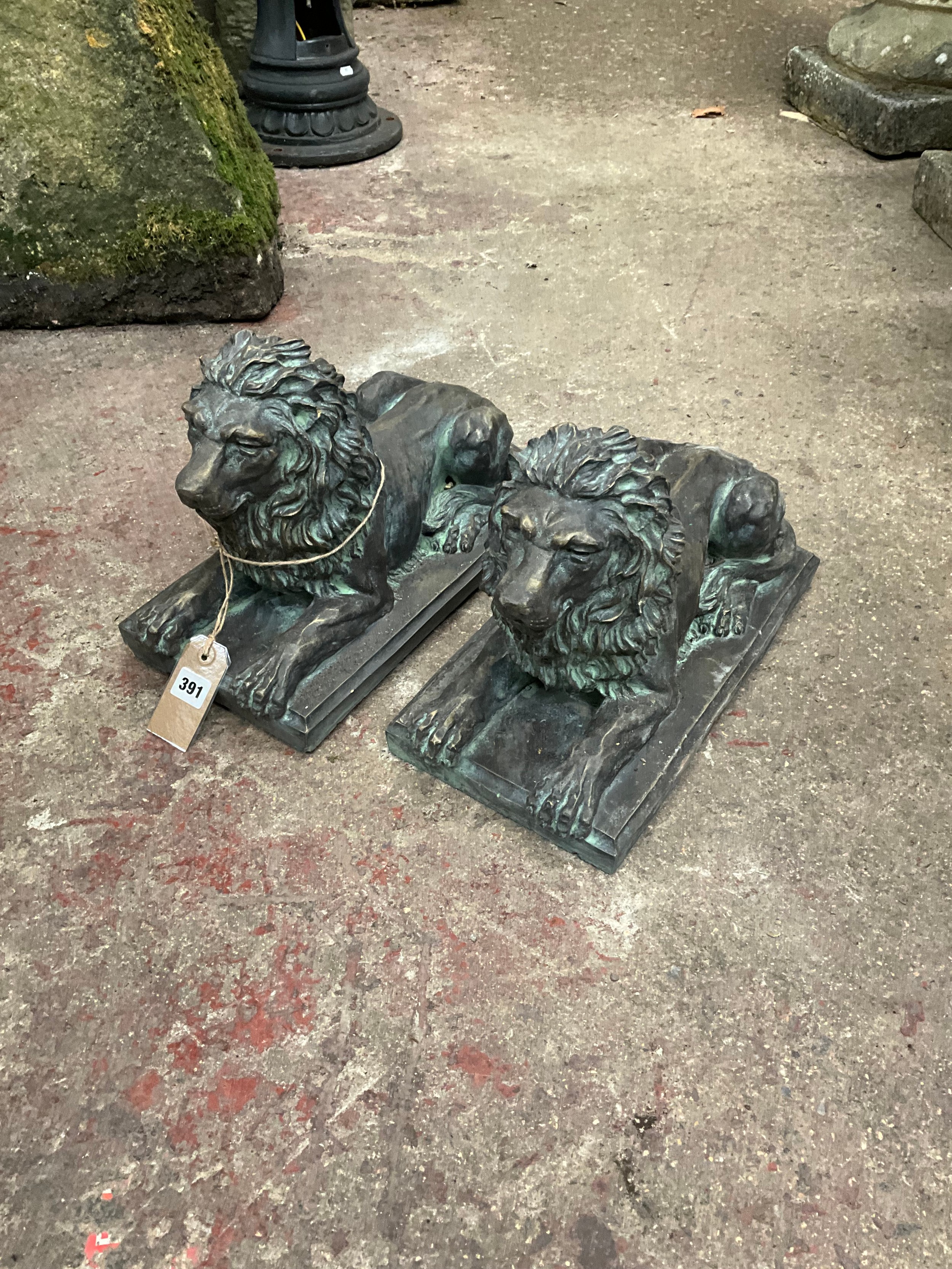 A pair of simulated, bronze models of recumbent Lions, with verdigris type finish, 27cm high, 39 x - Image 2 of 2