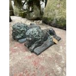 A pair of decorative cast simulated bronze recumbent lions, set on rectangular plinths, 20cm high,