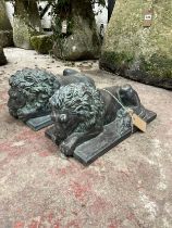 A pair of decorative cast simulated bronze recumbent lions, set on rectangular plinths, 20cm high,