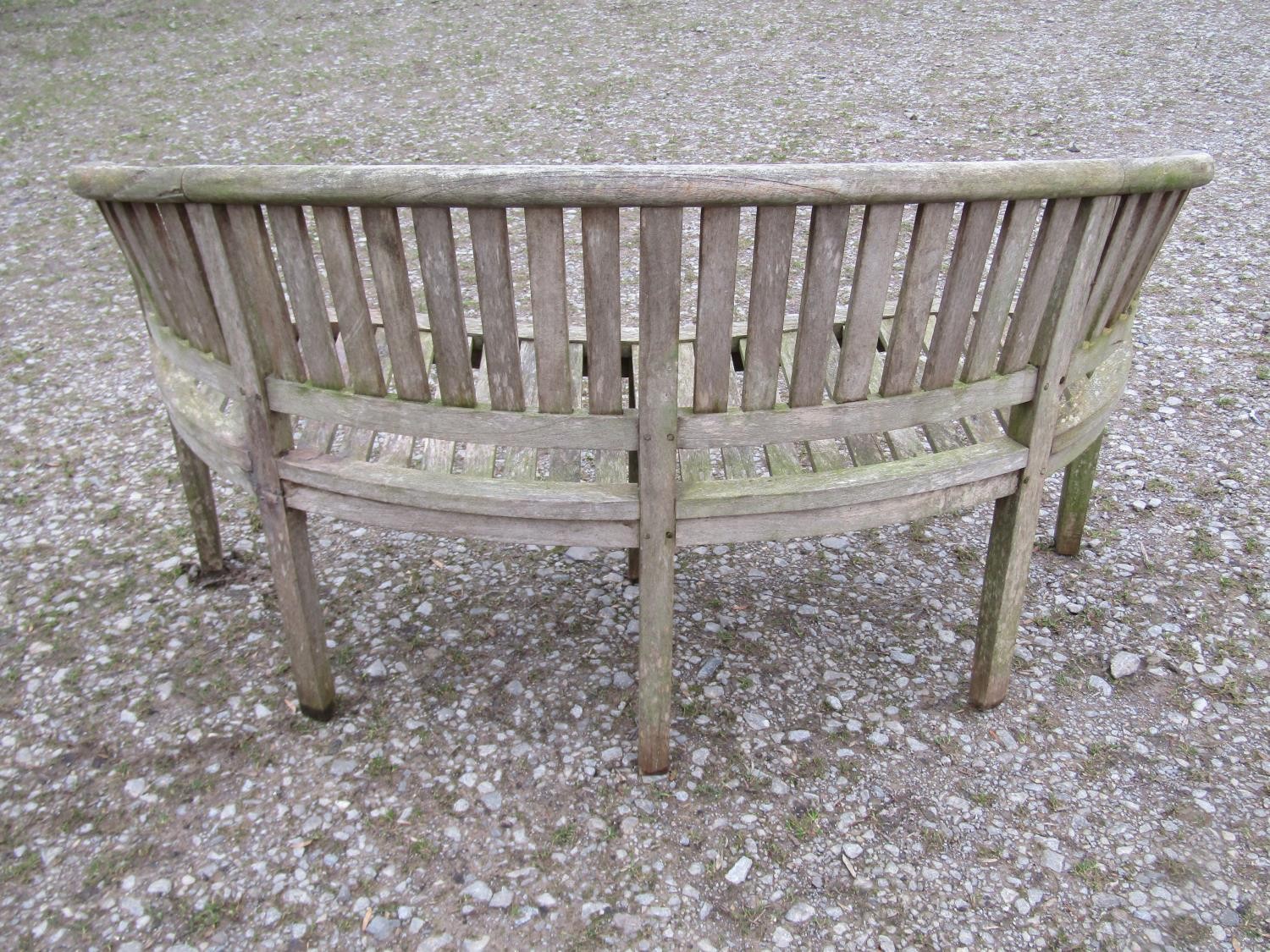 A weathered teak banana shaped garden bench, 156cm wide (af) - Image 2 of 3