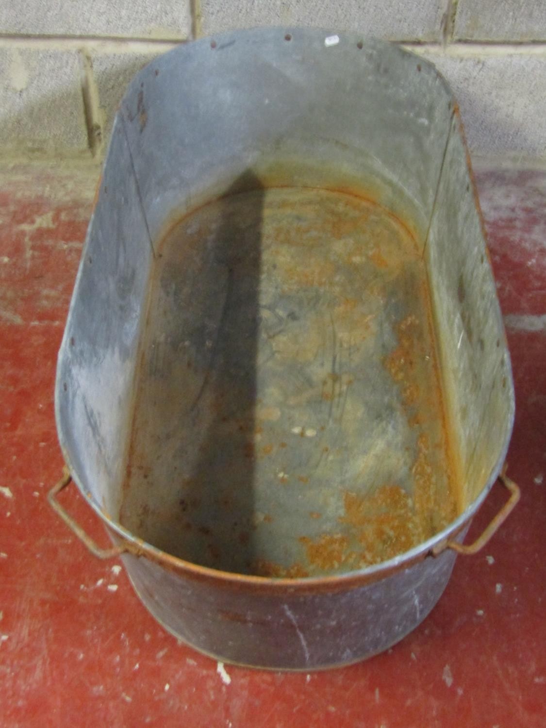 A vintage oval galvanised tin bath with iron fittings, 30 cm high x 119 cm x 55 cm - Image 3 of 3