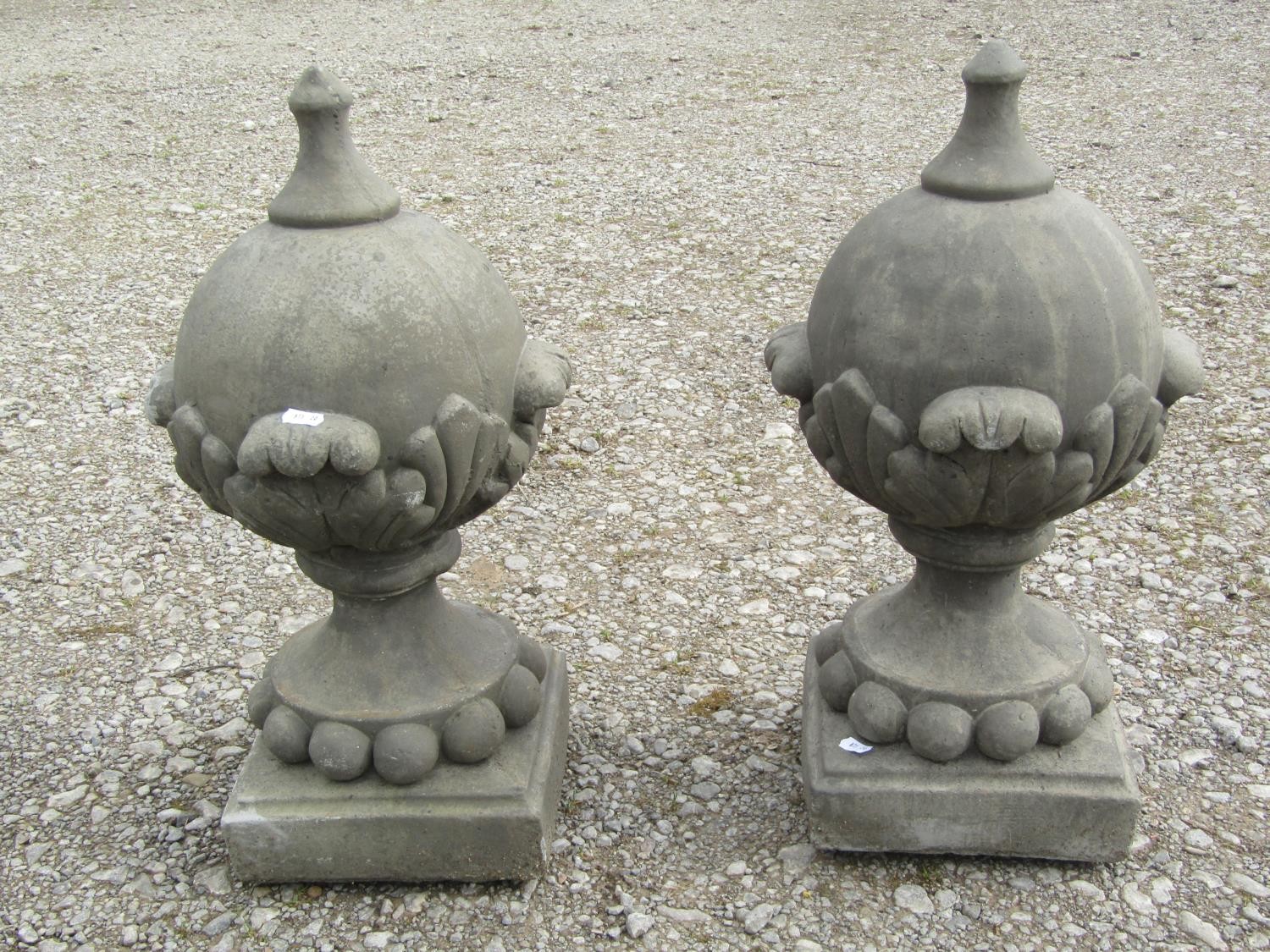 A pair of cast composition stone pointed sphere pier cap finials with acanthus detail 53 cm high