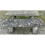 A pair of weathered cast composition stone three sectional garden benches with rectangular slab