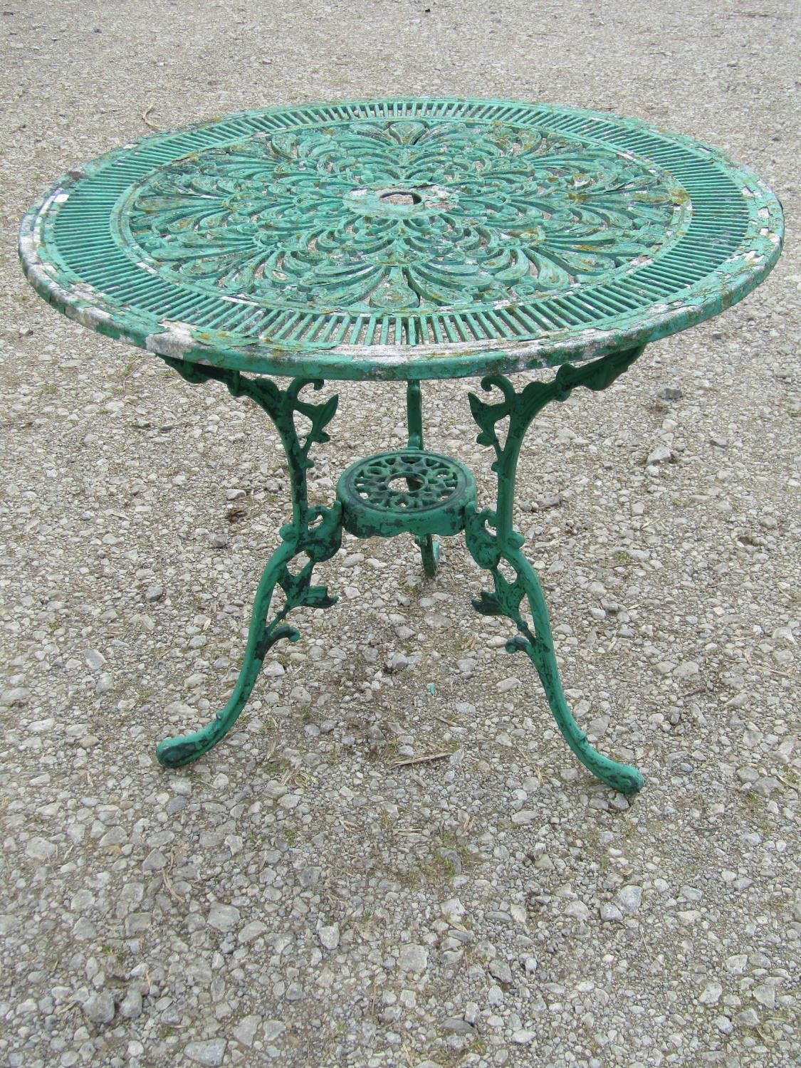 A weathered green painted cast aluminium garden terrace table of circular form with decorative - Image 3 of 4