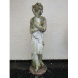 A partially painted and weathered cast composition stone garden ornament in the form of a standing