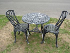 A contemporary cast alloy three piece garden Bistro set with pierced lattice detail, the table