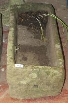 A small weathered natural carved stone planter/ trough of rectangular form with a drilled drainage