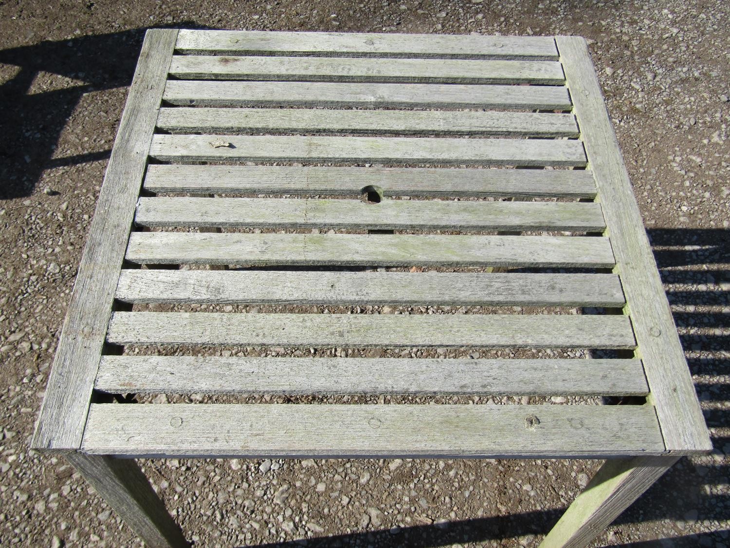 A weathered (silvered) teak garden suite comprising a folding bench with slatted seat and back 141 - Image 3 of 6