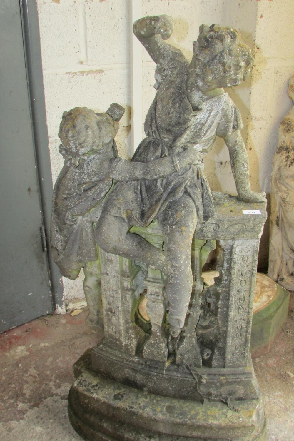 A 19th century weathered marble garden figure group, in the form of jostling infants on a