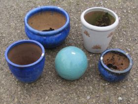 Four contemporary glazed garden planters of various size and design, one with moth detail together